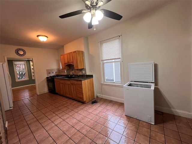 57 Prince St, Middletown, NY 10940 - kitchen with light tile patterned flooring, dark countertops, plenty of natural light, and gas stove