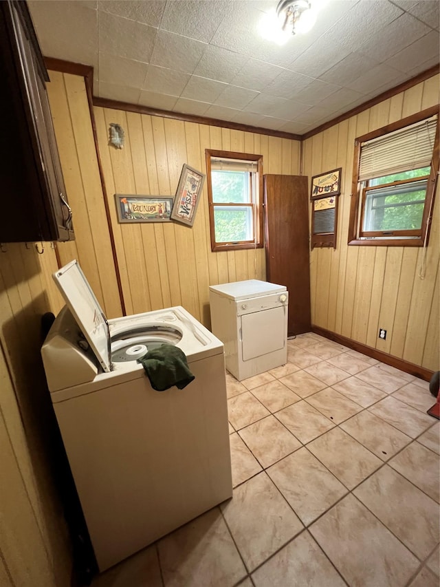 57 Prince St, Middletown, NY 10940 - washroom featuring laundry area, wood walls, washer and dryer, baseboards, and light tile patterned floors