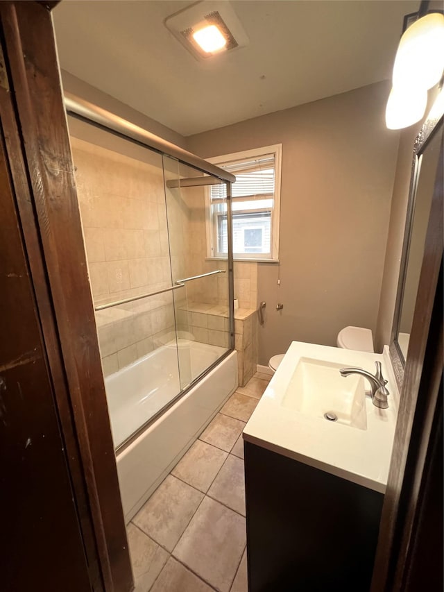 57 Prince St, Middletown, NY 10940 - full bath featuring combined bath / shower with glass door, tile patterned floors, vanity, and toilet