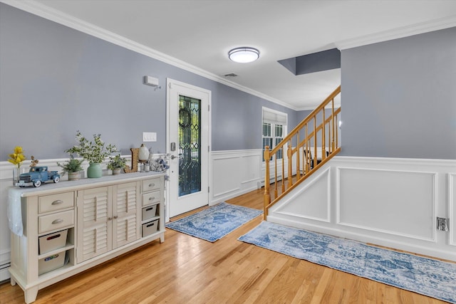 7 Karen Ct, Wading River, NY 11792 - foyer entrance with visible vents, ornamental molding, stairway, a wainscoted wall, and light wood finished floors