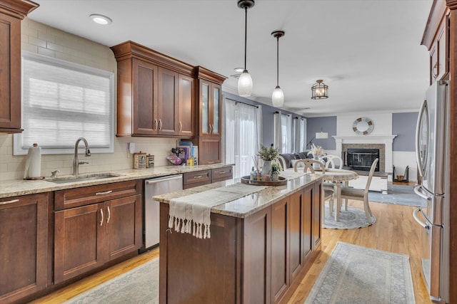 7 Karen Ct, Wading River, NY 11792 - kitchen with open floor plan, a sink, light wood finished floors, backsplash, and stainless steel appliances