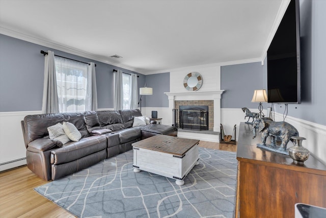7 Karen Ct, Wading River, NY 11792 - living room with wood finished floors, ornamental molding, and a wainscoted wall