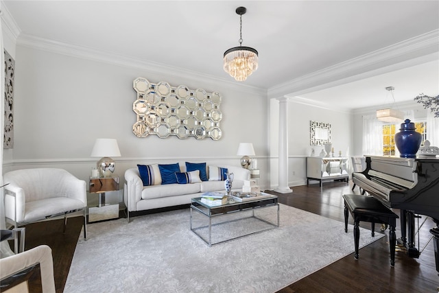 living area with crown molding, a notable chandelier, wood finished floors, and ornate columns