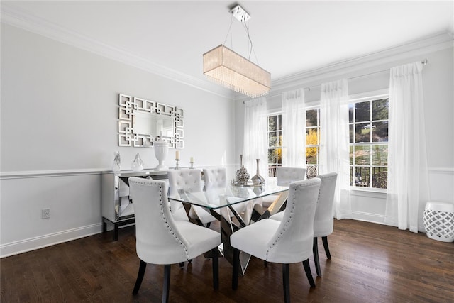 dining area with dark wood-type flooring, baseboards, and crown molding