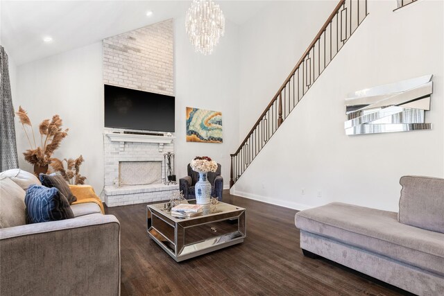 living area featuring stairs, a brick fireplace, baseboards, high vaulted ceiling, and dark wood-type flooring