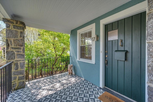 property entrance featuring board and batten siding