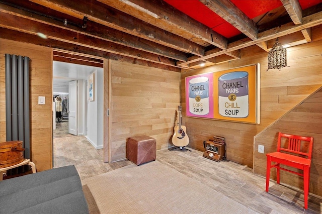 below grade area featuring wood walls and wood finished floors
