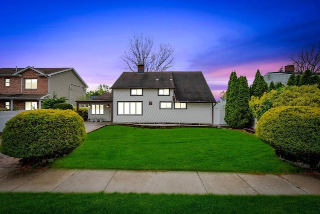 exterior space featuring a yard and a chimney