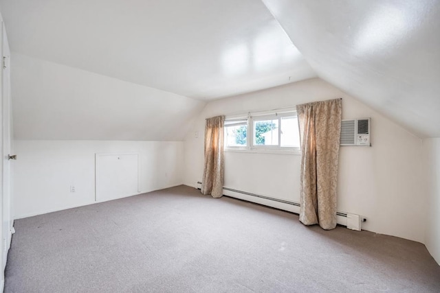 additional living space with an AC wall unit, light colored carpet, a baseboard heating unit, and lofted ceiling