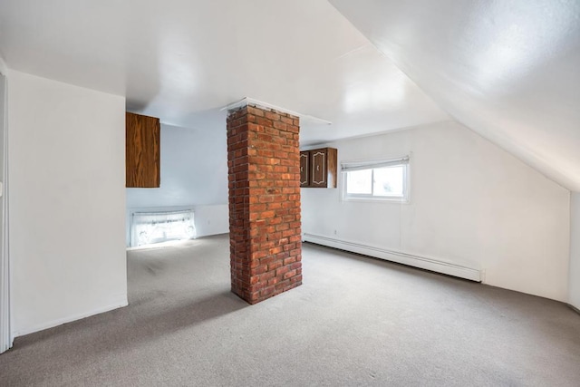 additional living space with carpet, baseboard heating, decorative columns, and lofted ceiling
