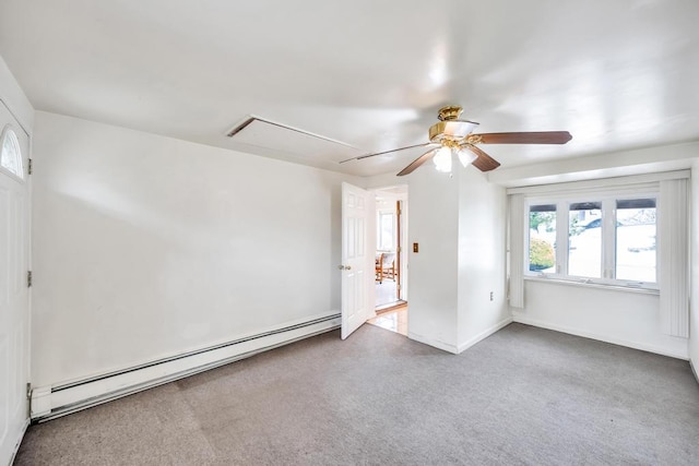 unfurnished room featuring ceiling fan, carpet, attic access, and a baseboard radiator