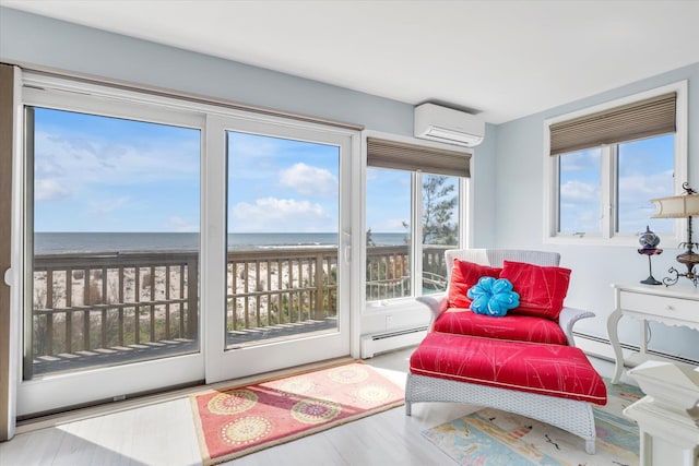 sunroom / solarium with a water view, a wall unit AC, and baseboard heating