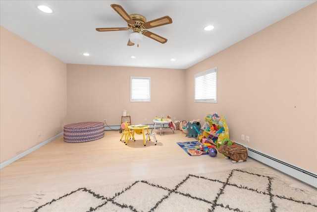 rec room with recessed lighting, a ceiling fan, wood finished floors, a baseboard radiator, and a baseboard heating unit