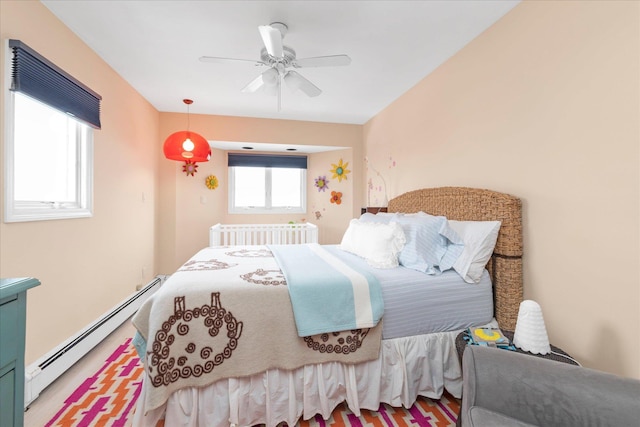 bedroom featuring ceiling fan, a baseboard heating unit, and radiator