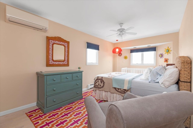bedroom with a wall mounted AC, light wood-type flooring, baseboards, a baseboard heating unit, and radiator heating unit