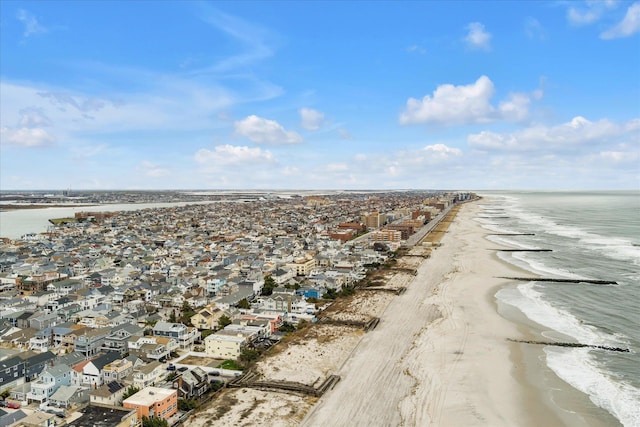 drone / aerial view with a water view, a beach view, and a residential view