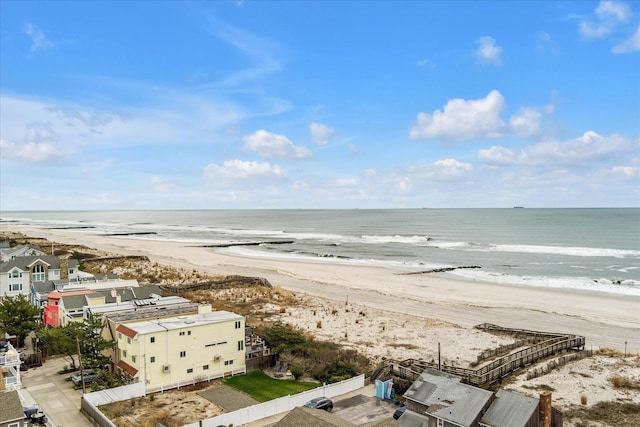 aerial view with a water view and a beach view