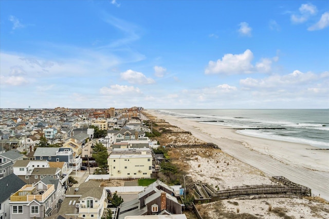 bird's eye view featuring a water view, a beach view, and a residential view