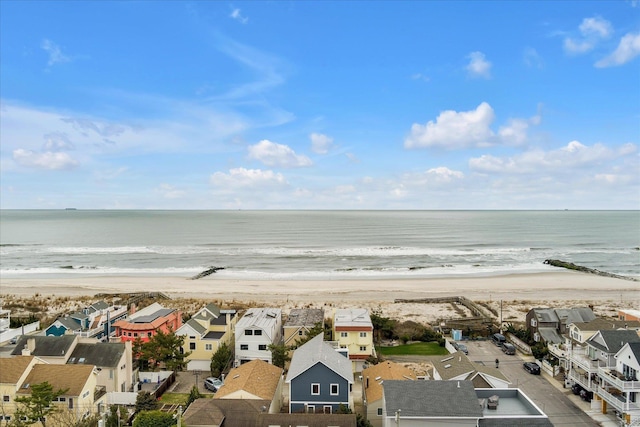 aerial view featuring a water view, a view of the beach, and a residential view