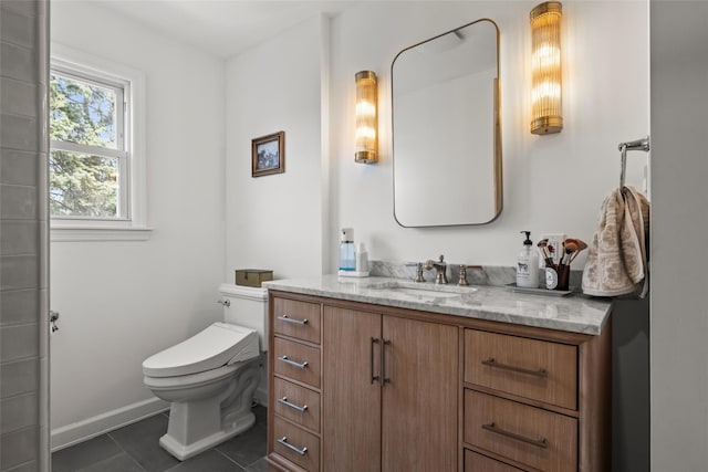bathroom with tile patterned floors, baseboards, vanity, and toilet