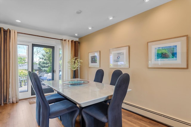 dining room featuring recessed lighting, a baseboard heating unit, and light wood-type flooring