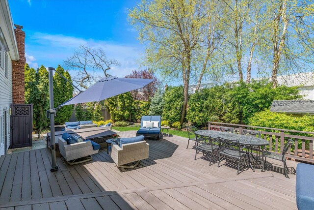 wooden deck with an outdoor living space and outdoor dining area