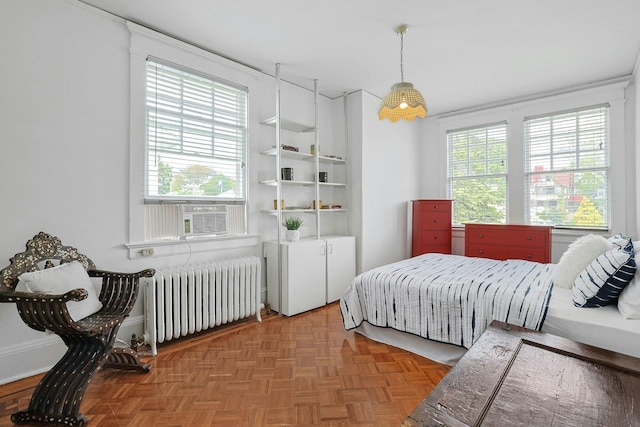 bedroom with radiator heating unit and cooling unit