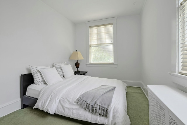 bedroom featuring radiator, carpet, and baseboards