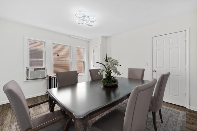 dining room featuring dark wood-style flooring, baseboards, and cooling unit