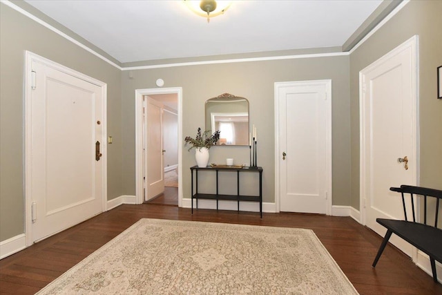 8 Barstow Rd Unit 6-D, Great Neck, NY 11021 - foyer with baseboards, ornamental molding, and dark wood finished floors