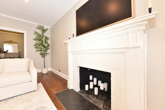 8 Barstow Rd Unit 6-D, Great Neck, NY 11021 - living area featuring baseboards, ornamental molding, a brick fireplace, and dark wood-style floors
