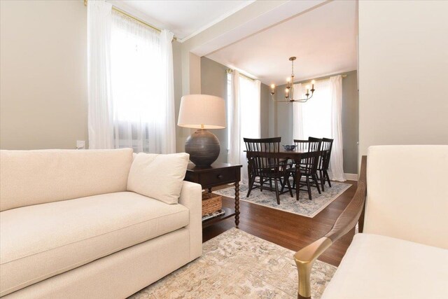 8 Barstow Rd Unit 6-D, Great Neck, NY 11021 - living area featuring an inviting chandelier and wood finished floors