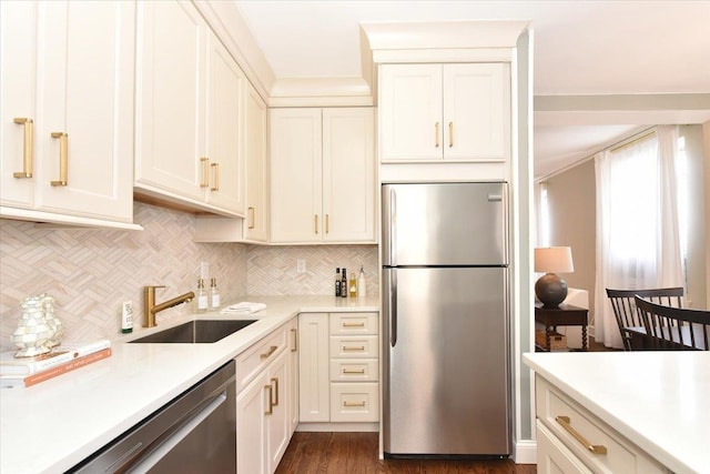 8 Barstow Rd Unit 6-D, Great Neck, NY 11021 - kitchen featuring tasteful backsplash, dark wood finished floors, a sink, light countertops, and stainless steel appliances
