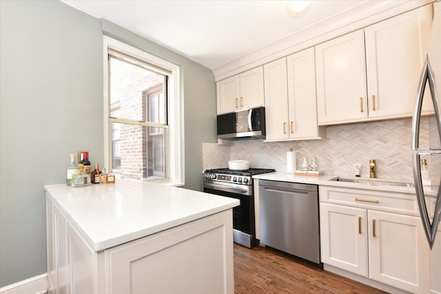8 Barstow Rd Unit 6-D, Great Neck, NY 11021 - kitchen featuring light countertops, a sink, appliances with stainless steel finishes, and tasteful backsplash