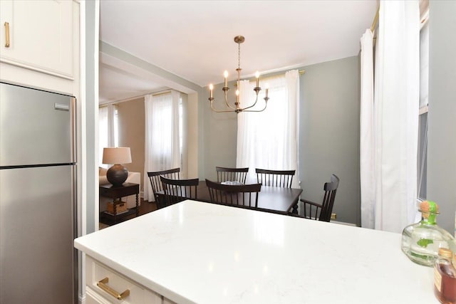 8 Barstow Rd Unit 6-D, Great Neck, NY 11021 - dining space featuring a wealth of natural light and a notable chandelier