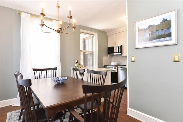 8 Barstow Rd Unit 6-D, Great Neck, NY 11021 - dining room featuring an inviting chandelier, baseboards, and dark wood-style floors