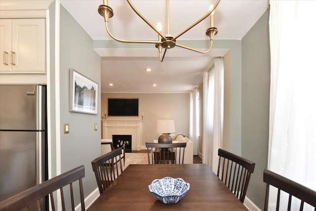 8 Barstow Rd Unit 6-D, Great Neck, NY 11021 - dining room featuring an inviting chandelier, baseboards, a fireplace, and recessed lighting