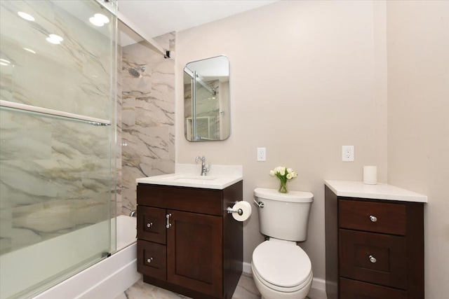 8 Barstow Rd Unit 6-D, Great Neck, NY 11021 - bathroom featuring toilet, baseboards, bath / shower combo with glass door, and vanity