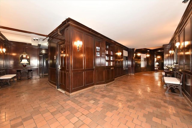 8 Barstow Rd Unit 6-D, Great Neck, NY 11021 - interior space with ornamental molding, a decorative wall, and brick patterned floor