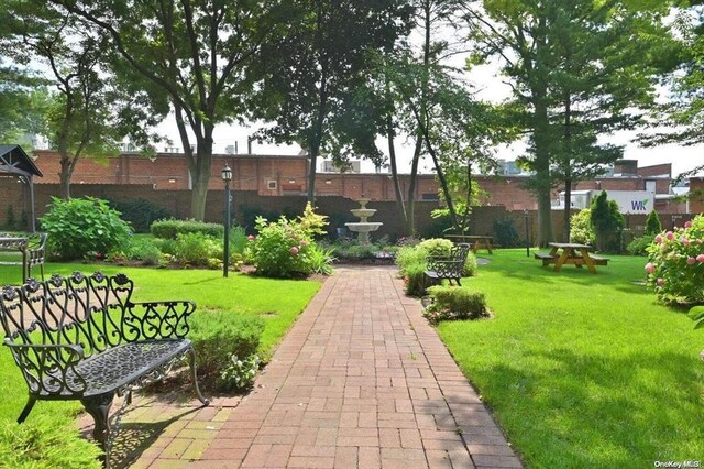 8 Barstow Rd Unit 6-D, Great Neck, NY 11021 - view of community with a lawn and fence