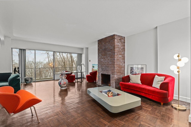 living room featuring baseboards and a fireplace