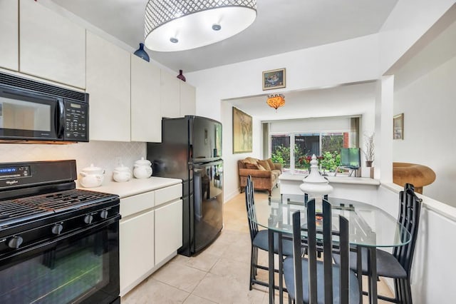 kitchen with light tile patterned flooring, light countertops, white cabinets, backsplash, and black appliances