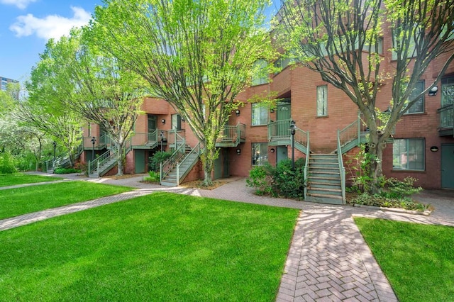 view of property featuring a front yard and stairway