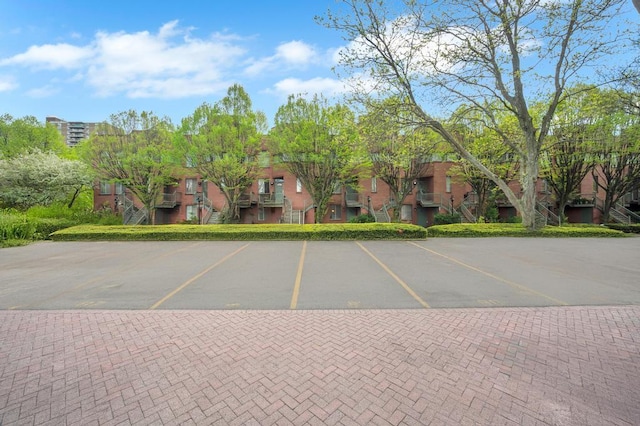 uncovered parking lot featuring a residential view and stairway