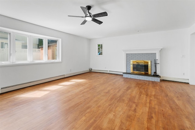 unfurnished living room featuring a ceiling fan, wood finished floors, a fireplace, baseboards, and a baseboard radiator