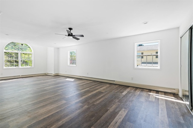 empty room with baseboards, ceiling fan, a baseboard heating unit, and wood finished floors