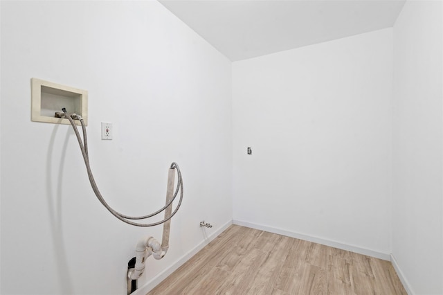 laundry area with laundry area, light wood-style floors, hookup for a washing machine, baseboards, and gas dryer hookup