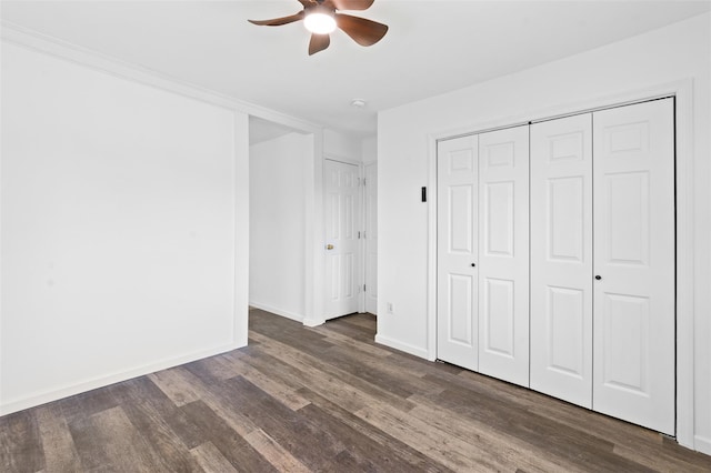 unfurnished bedroom with baseboards, dark wood finished floors, and ceiling fan