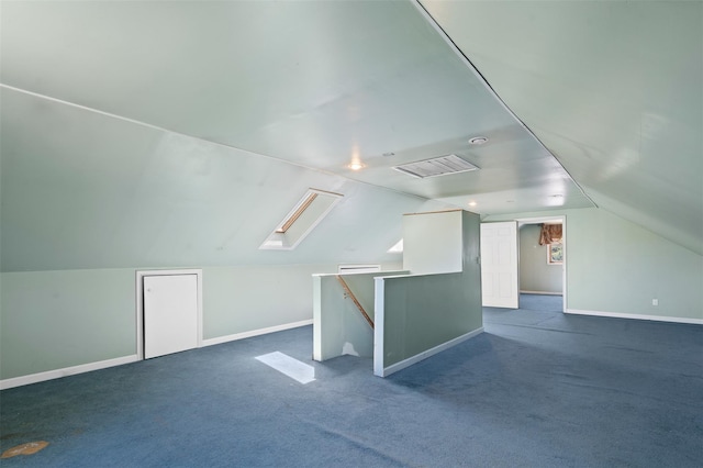 bonus room with baseboards, vaulted ceiling with skylight, and dark colored carpet