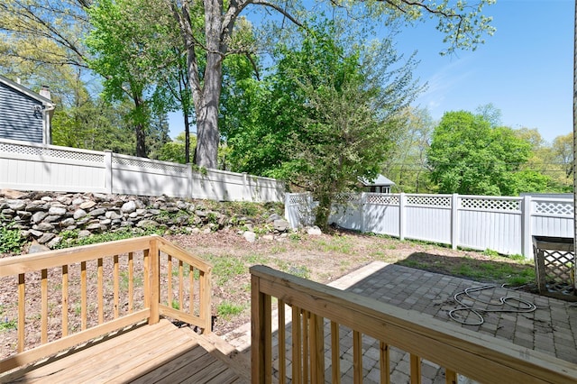 deck featuring a fenced backyard and a patio area